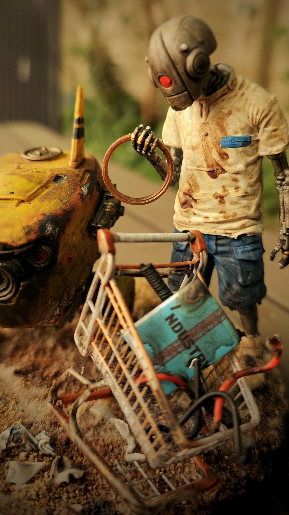 Close detail of the salvage robot holding a found ring beside RoboChick