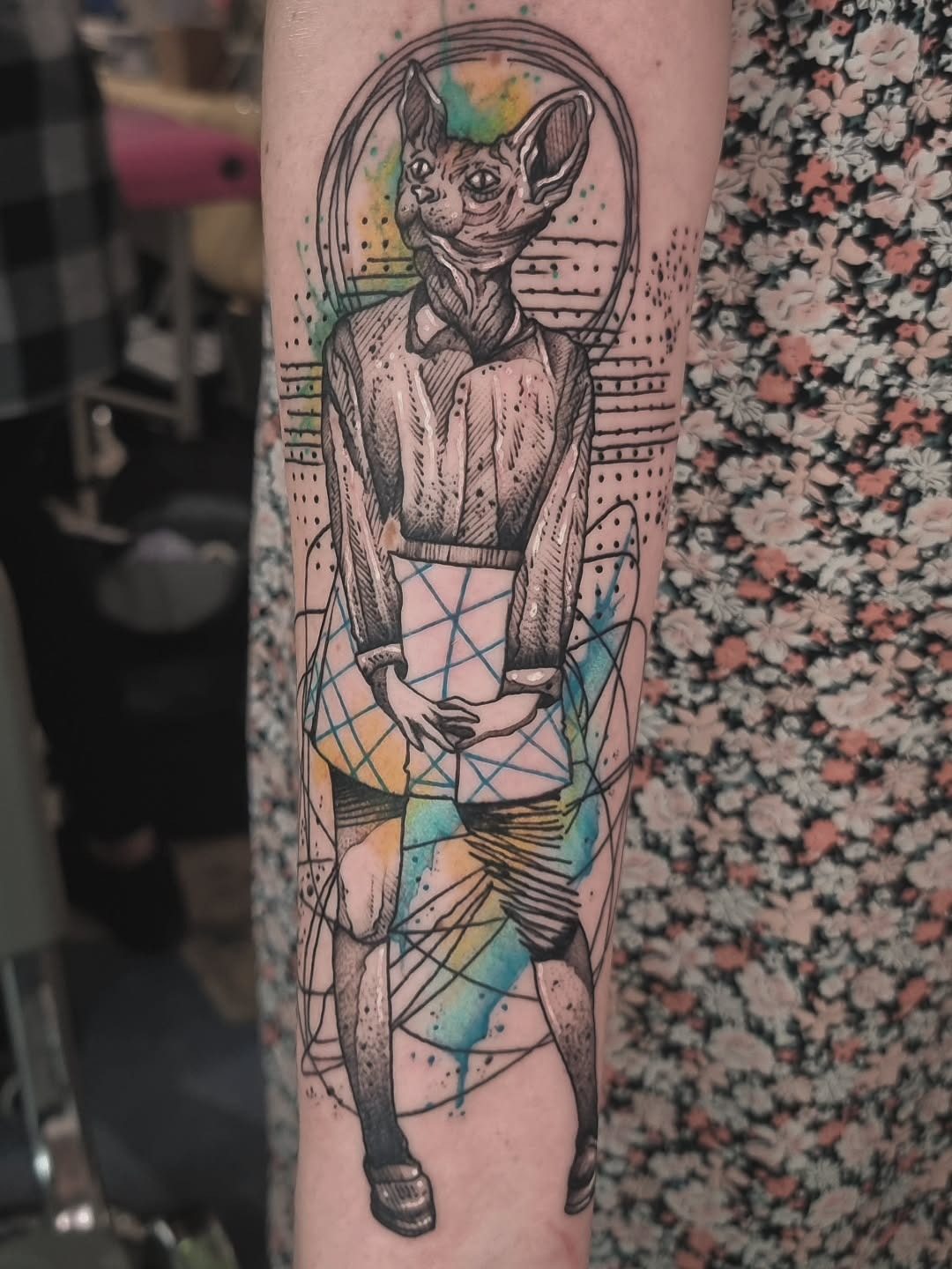 Humanism tattoo of a humanoid animal figure with geometric lines