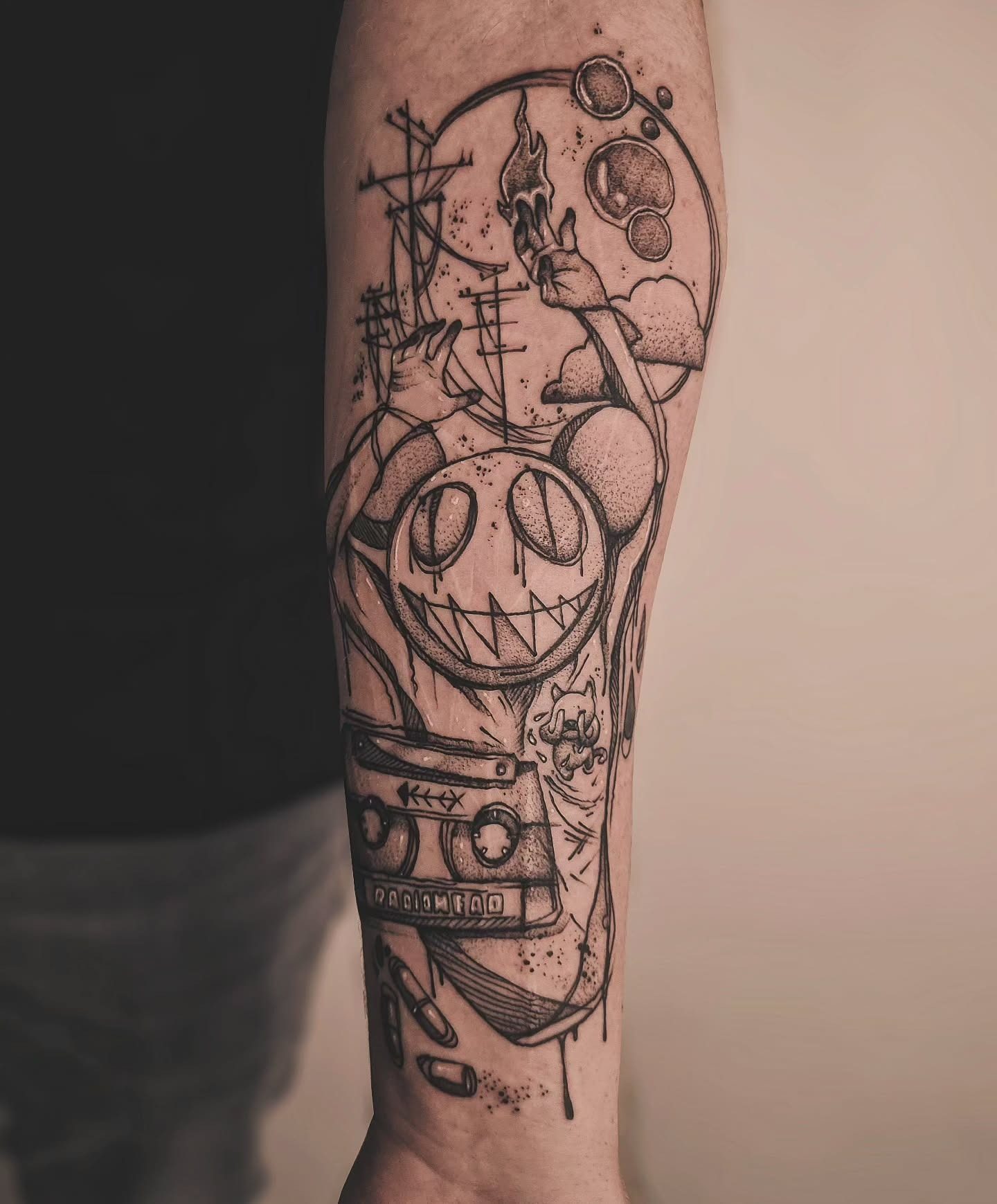 Humanism tattoo with smiling figure and objects